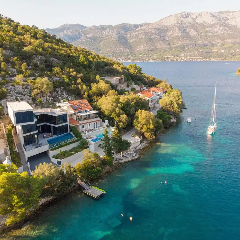 The villa captured from above, set against turquoise waters