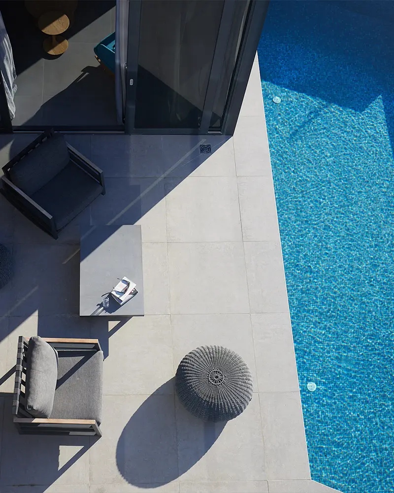 Terrace of the villa captured from above, showing a section of the pool