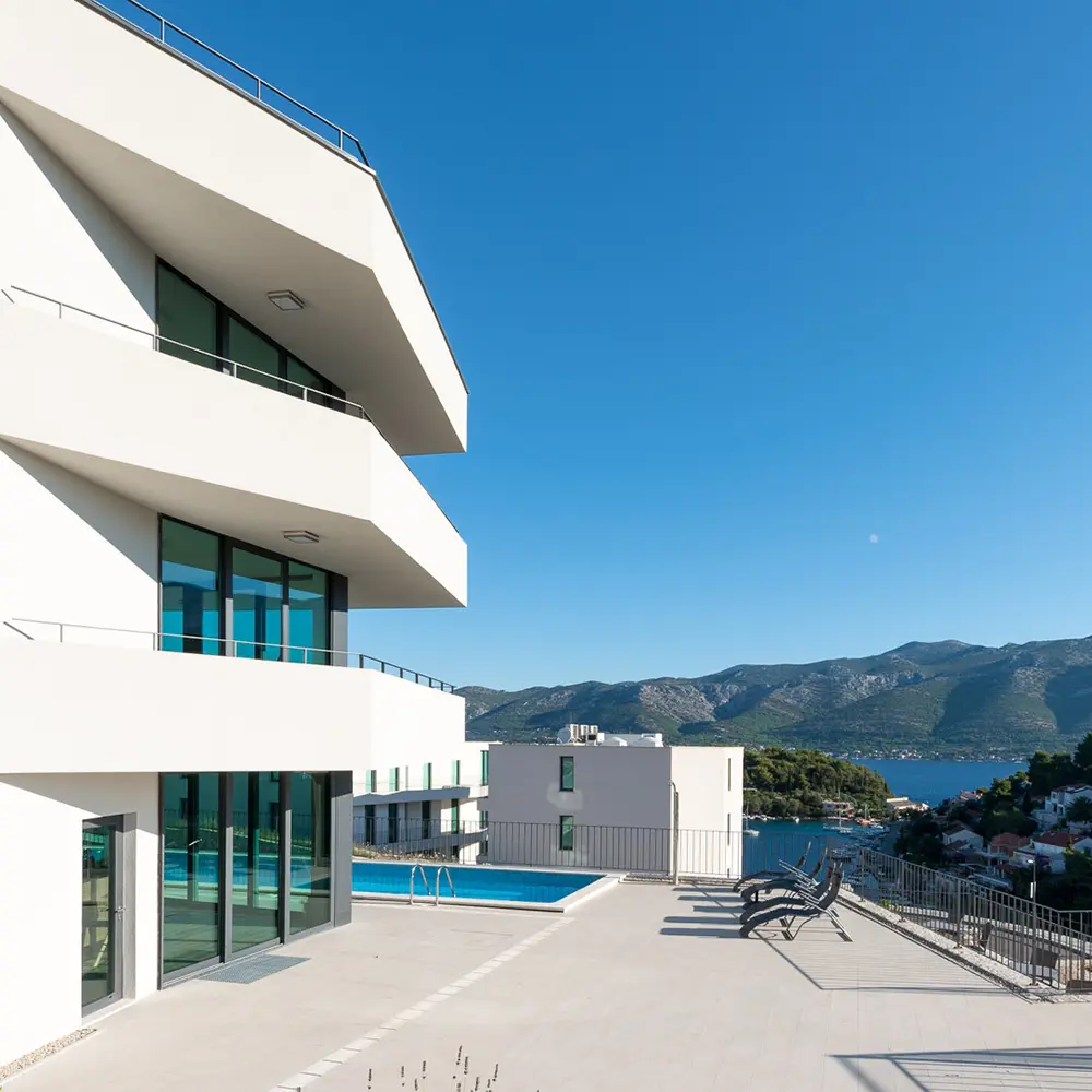 The villa captured from above, set against turquoise waters