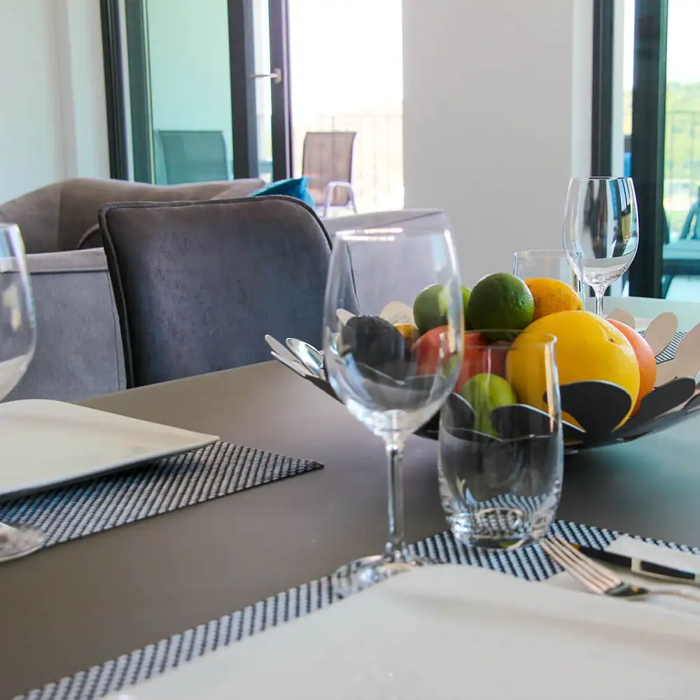 glass of wine and fruits on table in penthouse oleander 5